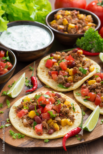 tortillas with chili con carne and tomato salsa on wooden board Plakát