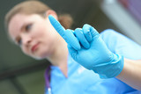 woman doctor in <b>medical gloves</b> - 160_F_69316372_h7ZLB0ZqGJdXLfrAjSOmJ7l3ZyzOErcm