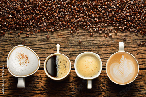 Zdjęcia Variety of cups of coffee and coffee beans on old wooden table