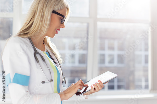 Zdjęcia Female doctor looking at medical records on tablet computer