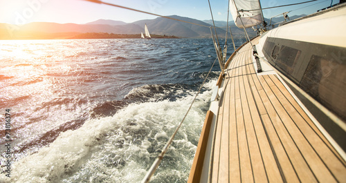 Yacht sailing towards the sunset. Sailing. Luxury yachts.