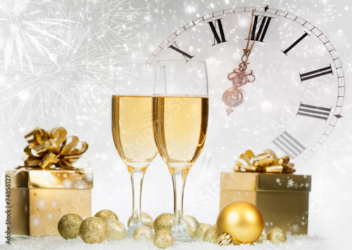 Champagne and gift box against fireworks and holiday lights