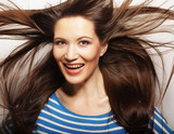 Young woman <b>with wind</b> in hair - 160_F_78242393_Vuba3ck4kHMoTFvJNEfNjFsVLd9UFPja