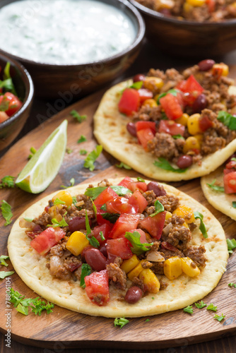 Vászonkép tortillas with chili con carne and tomato salsa on wooden board