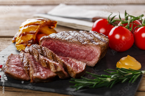 Zdjęcia grilled beef steak rare sliced with vegetables
