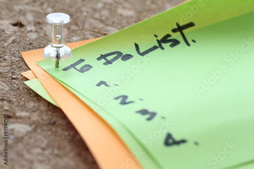 Poster close up on pin and to do list word on sticky note with cork boa