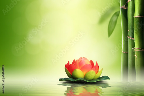  Zen concept. Orange lotus in bamboo forest.
