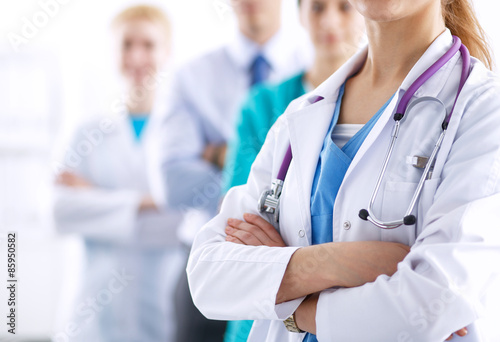 Attractive female doctor in front of medical group