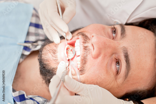 Zdjęcia young happy man and woman in a dental examination at dentist