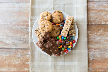 Fototapeta close up of candies, chocolate, muesli and cookies