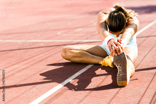 Zdjęcia Beautiful young athletic woman stretching in summer