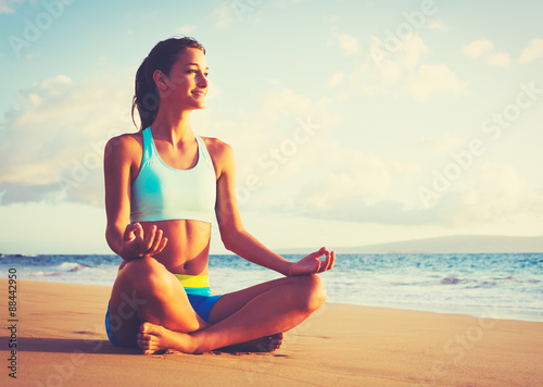 Zdjęcia Woman Practicing Yoga on the Beach at Sunset