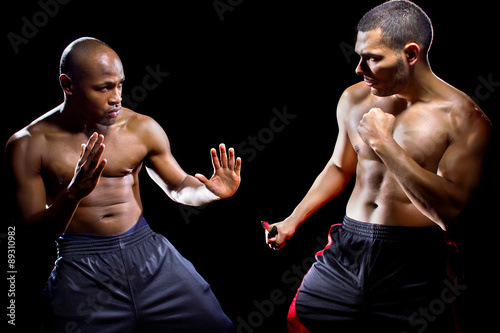 Poster Martial arts instructor demonstrating self defense against a knife attack