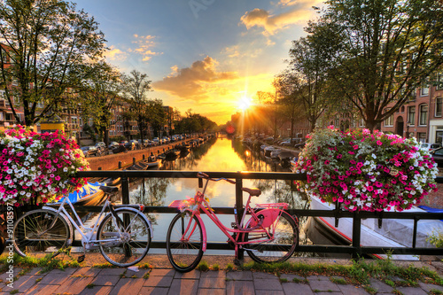 Poster Beautiful sunrise over Amsterdam, The Netherlands, with flowers and bicycles on