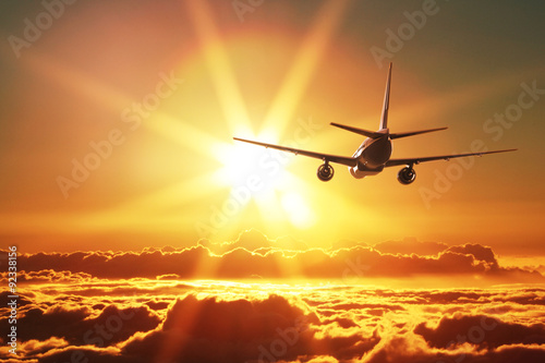 Plane is taking off at sunset