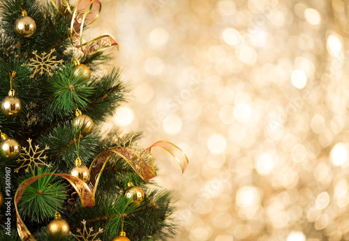 Christmas tree background with gold blurred light