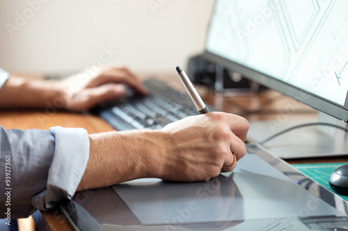 Poster Graphic designer using digital tablet and computer in office or