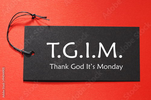 TGIM text on a black tag