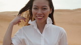 Asian woman smile outdoor desert wind blowing hair