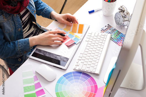 Poster Young Handsome Graphic designer using graphics tablet to do his