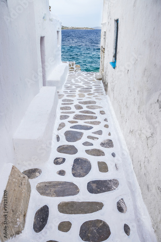Fototapeta Traditional whitewashed alley of Mykonos with seaview, Greece
