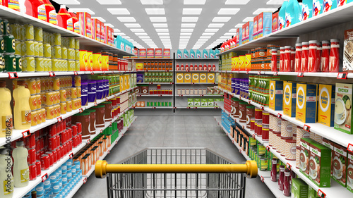 Supermarket interior with shelves full of various products and empty trolley basket
