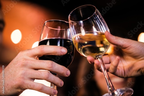 Poster Close up of friends toasting with wine