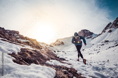 Man running on the snow on a mountain