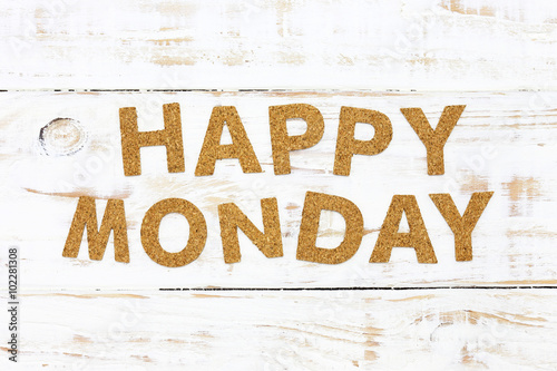 The word happy monday cork on white wood background