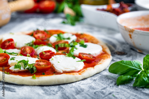 Poster Prepering margherita pizza with mozzarella for baking