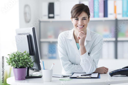 Attractive doctor posing at the clinic reception