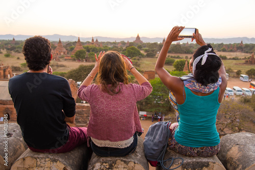 Poster Tourists looking at sunset in Ancient Temples at Bagan, Myanmar