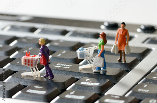 Miniature shoppers with shopping cart