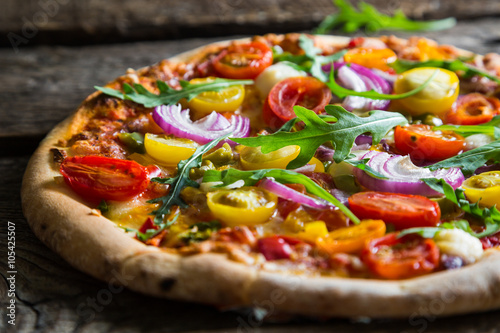 Poster Pizza with arugula and cherry tomatoes