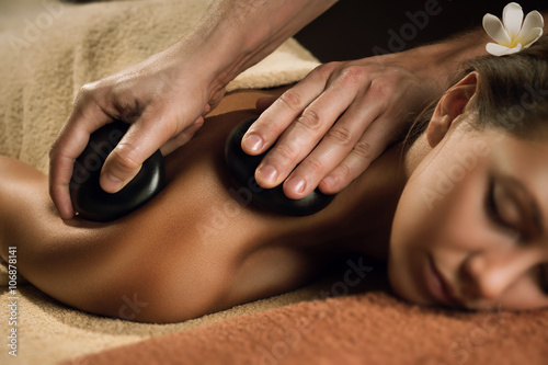 Beautiful girl has stone massage.