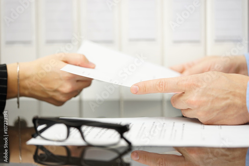 manager is giving employee termination of contract to read