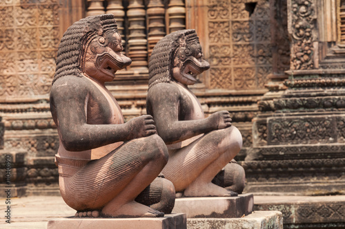 Poster Monkey guardians in the Banteay Srey hindu khmer temple , Angkor Wat, Cambodia