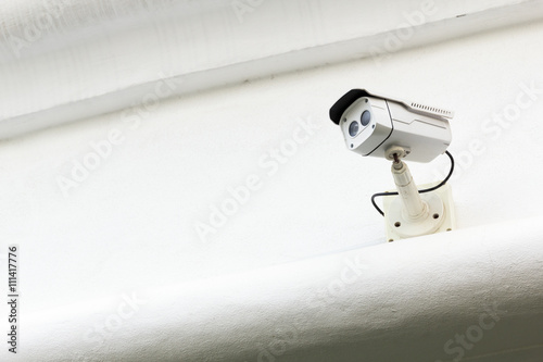 Poster The CCTV Security Camera operating in the white terrace backgrou