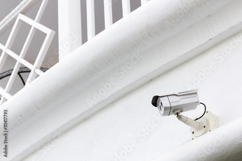 Poster The CCTV Security Camera operating in the white terrace backgrou