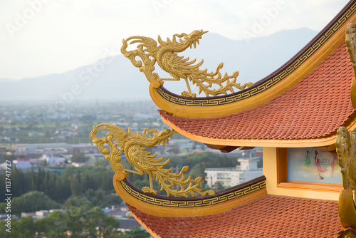 Poster, Tablou Fabulous bird on the roof of a Buddhist pagoda Buu Son, Vietnam