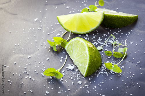 Lime Wedges with Sea Salt and Micro Herbs over Slate