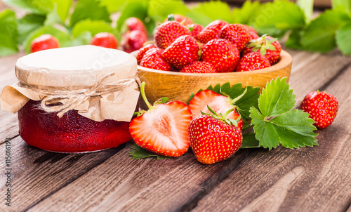 Strawberry on wood background. Strawberry with green leaves.