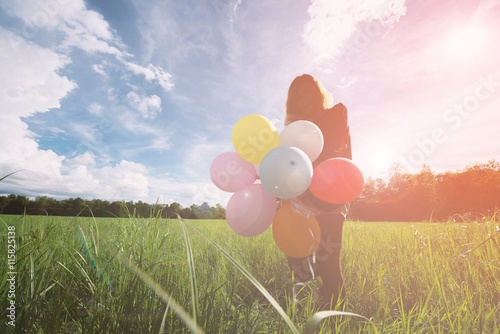 Poster imagination and creativity, girl with multicolored balloons at sunset with copys