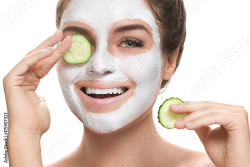 Poster, Tablou Woman with facial mask and cucumber slices in her hands