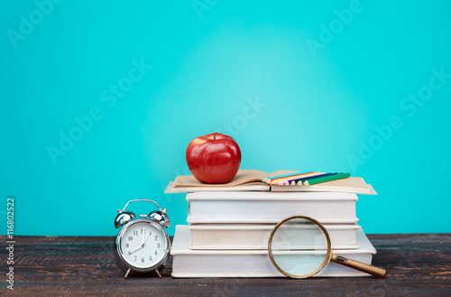 Poster Back to School concept. Books, colored pencils and clock
