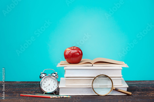 Poster Back to School concept. Books, colored pencils and clock