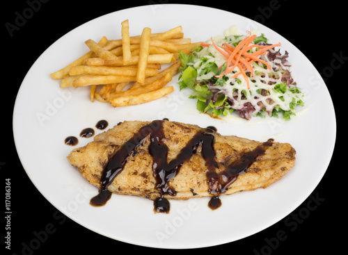 Poster Fish fillet with french fries and salad isolated on the black background with cl