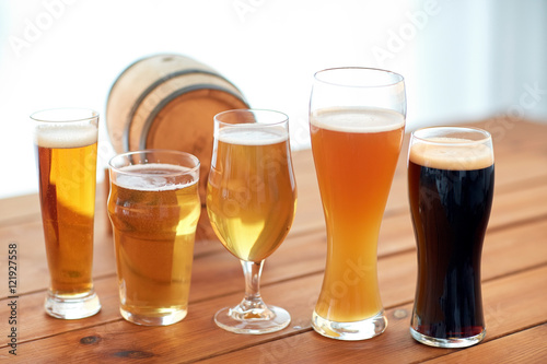 close up of different beers in glasses on table Poster