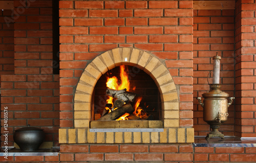 Russian interior kitchen with an oven and a burning fire