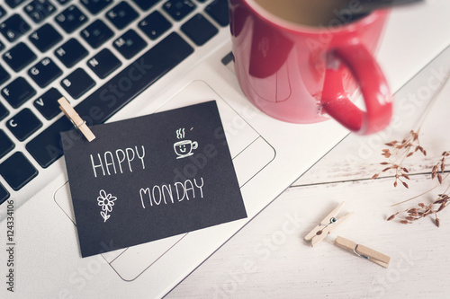 Happy Monday massage on notebook with coffee